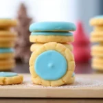 A plate of golden-brown cream-filled Madeline cookies with a smooth white cream filling inside, elegantly arranged for serving